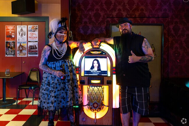 Customers pose at the jukebox at Guthries Alley Cat in Downtown Bakersfield.