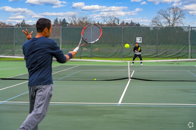 Friends practice tennis at the Johnson Springview Park tennis courts close to Woodside.
