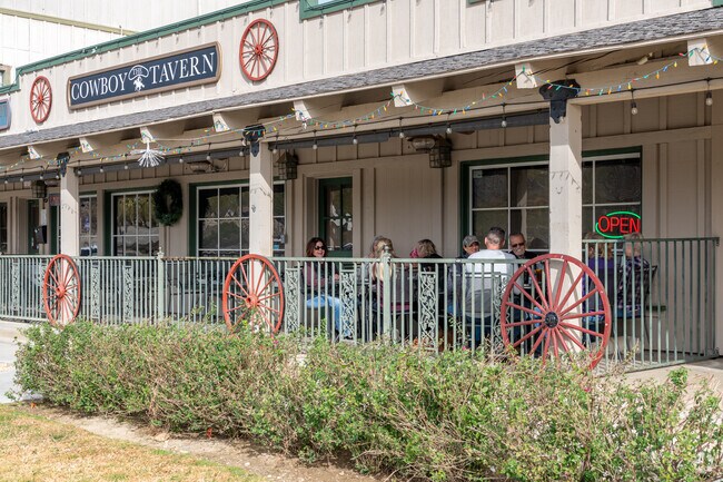 Residents enjoy lunch on the porch of The Cowboy Tavern.