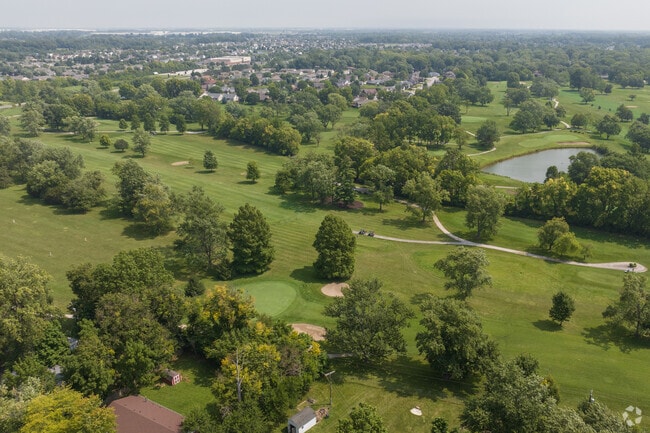 An aerial view of the beautiful wooded greens of the Maple Creek Country Club on East 21st St.