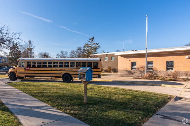 A bus pulls up in front of Indian Grove Elementary School to drop students off.