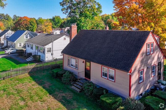 Various Cape Cod homes with beautiful colors line the residential streets of Southeast Nashua.