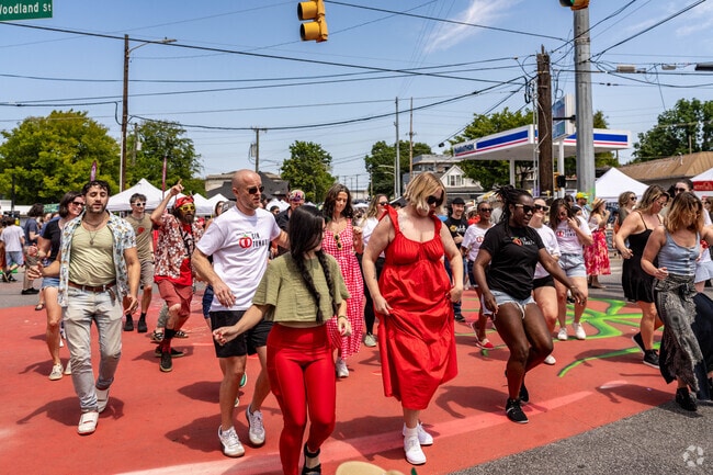 People enjoy dancing on the Tomato Street Mural at the Tomato Art Fest.