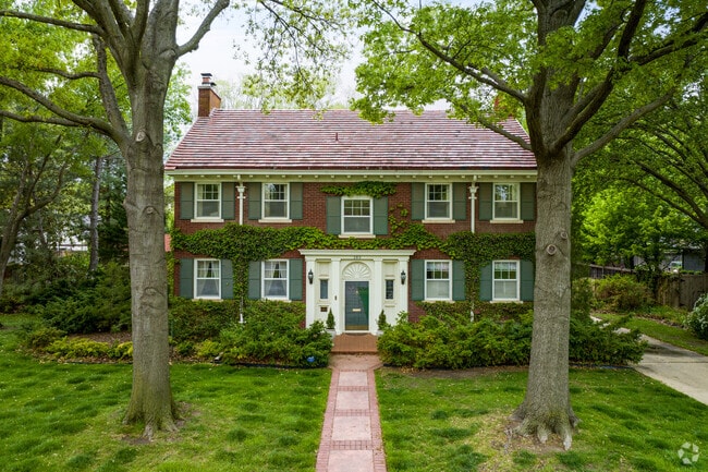 Well-kept lawn with brick walkway leading to this College Hill home.