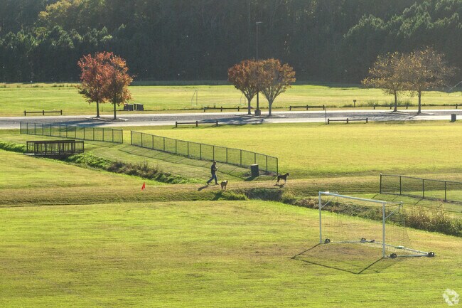 A man walks his dogs at the nearby Centerville Park in Pleasant Grove East.