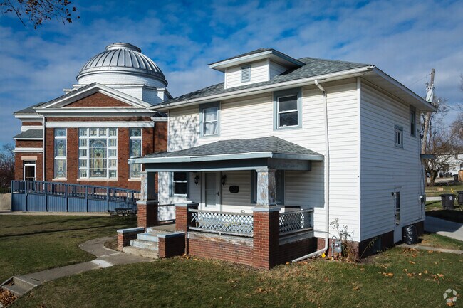 This spacious front porch protects from the sun on a summer day in Williams Park.