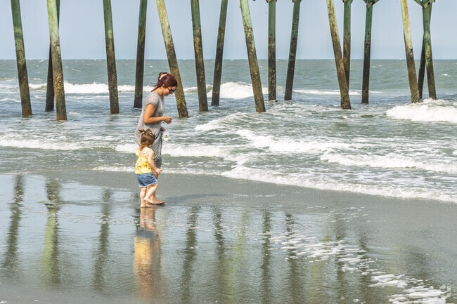 A mother and daughter stroll the shoreline near Grande Dunes enjoying the ocean breeze.