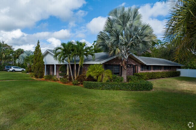 Single-family home with lush front yards in Wynmoor, Coconut Creek.