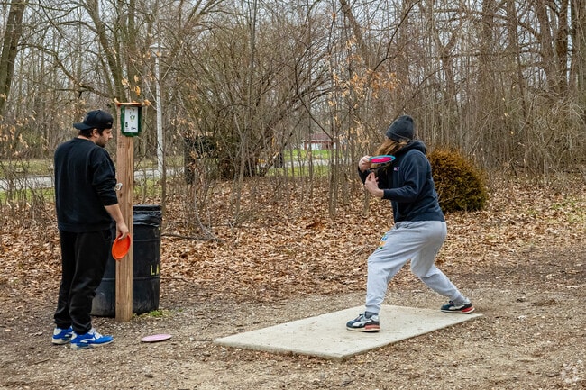 Disc golfers come to Ingham Park to practice their throw on the course's challenging runs.