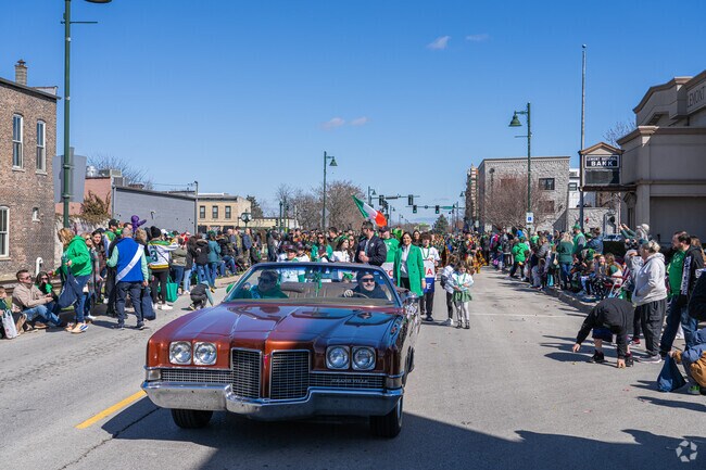 A classic car cruises at the St. Patrick's Parade in Lemont.