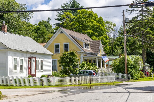 A row of homes including Cape Cod inspired cottages and New England styles in Sutton, NH.