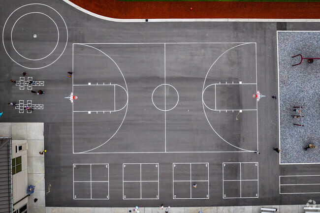 A basketball court and other activities are painted on top of this blacktop area at Challenger