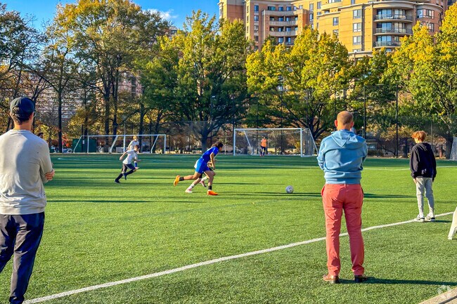 People kicking it on the well-maintained playfield at Virginia Highlands Park.