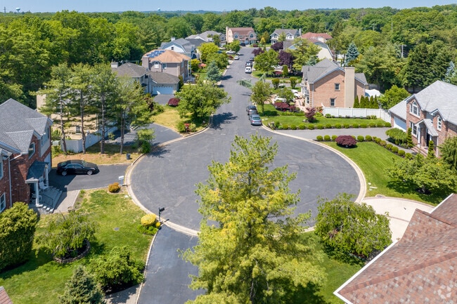 Large, beautiful homes line this neighborhood road in Old Westbury.