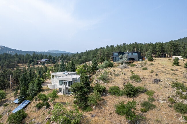 Modern architecture blends with rugged terrain in Seven Hills, offering stunning mountain vistas