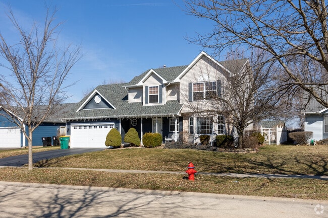 Large single family homes sit on well-maintained lawns in Crest Hill.