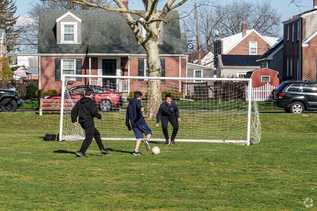 These teenagers get some soccer practice in at Newcomer Academy Park in Midway Manor.