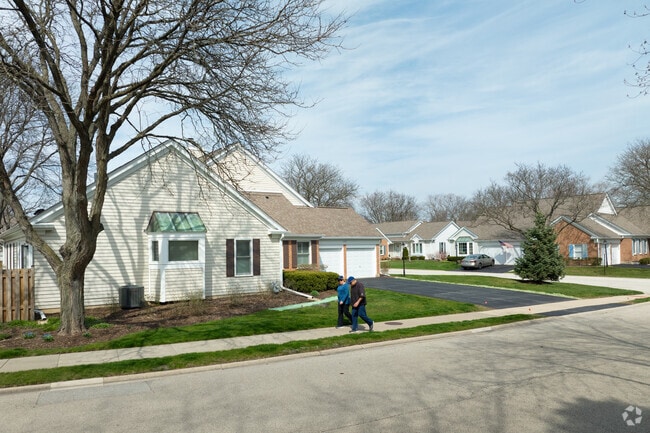 Residents of Prospect Heights walk along a row of homes in the neighborhood.