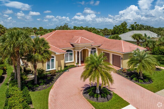 Custom Mediterranean style homes with circular driveways in Boca Royale.