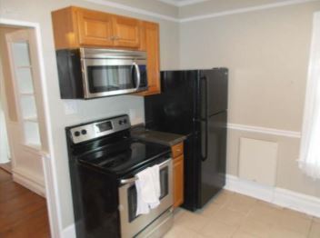 Kitchen with like-new refrigerator, range, and microwave.