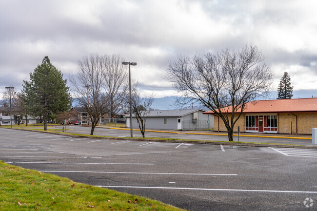The Continuous Curriculum school features a large parking lot in front of the school.