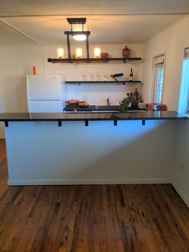 granite bar top to wall between kitchen and living room