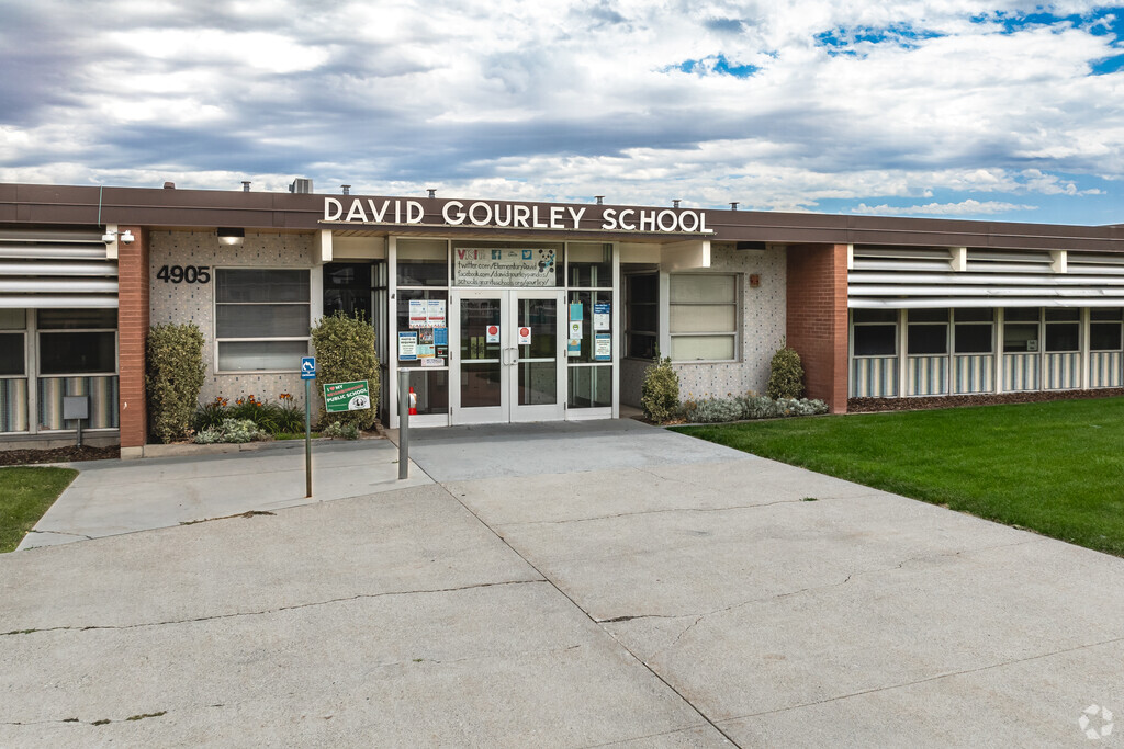 A wide sidewalk leads to the entrance at David Gourley Elementary School.