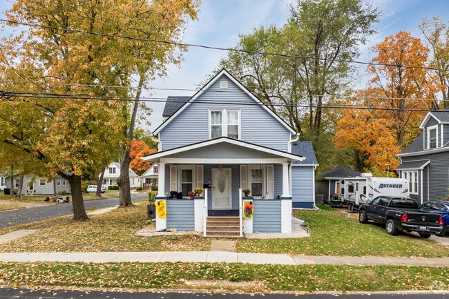 A bungalow-style home in Bloomington's South Hill features a front porch and light-blue siding.