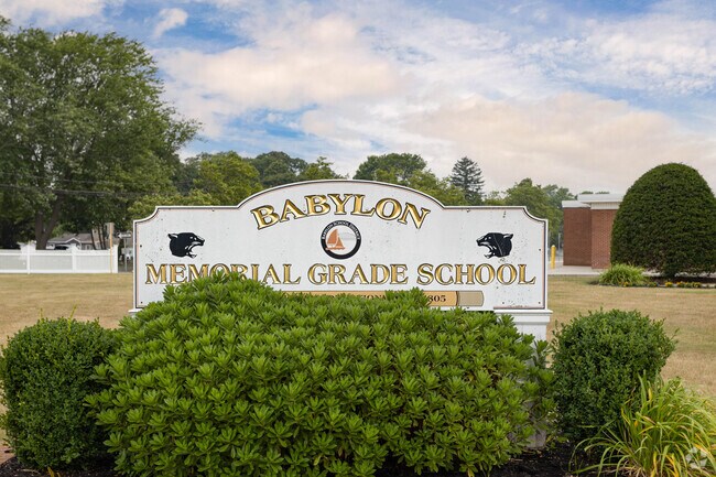 Signage in front of Babylon Memorial Grade School in Babylon, NY identifies the school.