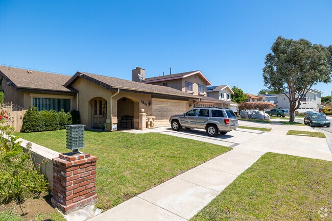 The residential streets of Athens are lined with midcentury ranch style homes with small front yards.