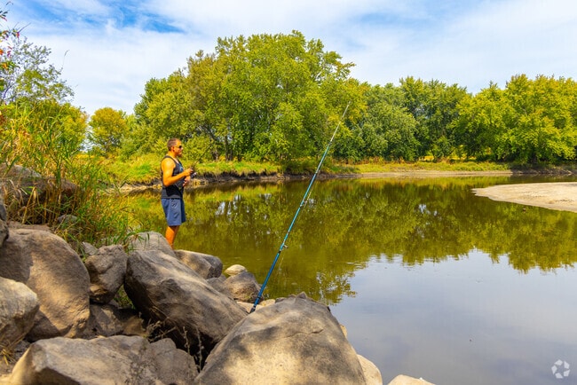 A fisherman casts from the banks of the Fox River.