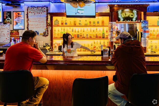 Locals enjoy conversation and drinks a Rich's Parkside Den in Boston.