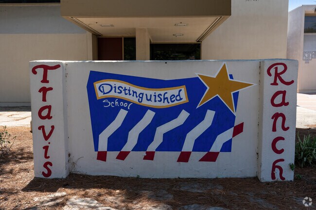 Hand made school sign in front of Travis Ranch Middle School shows school spirit.