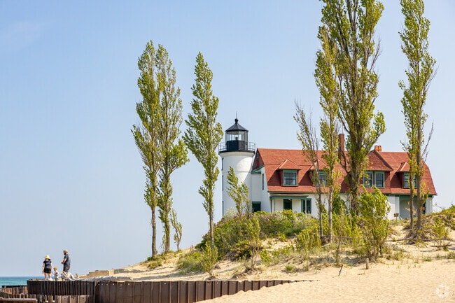 Families across Michigan come take photos in front of Point Betsie Beach's historic Lighthouse.
