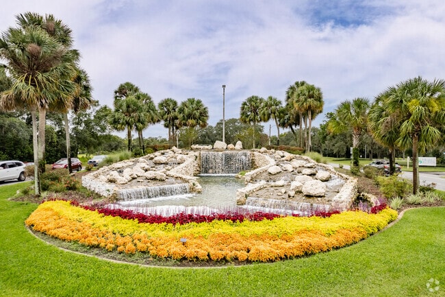 The amazing waterfall entrance surrounded by colorful flowers in Marion Oaks.