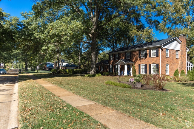 Colonial revival homes are abundant in a nature rich street setting in Des Peres.