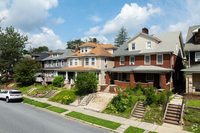 Historic homes line a quiet road in Palmerton, surrounded by scenic mountain beauty.