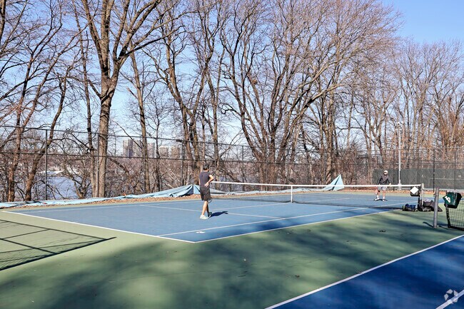 Residents of Manhattanville enjoy a day of tennis at the Riverdale Park tennis courts.