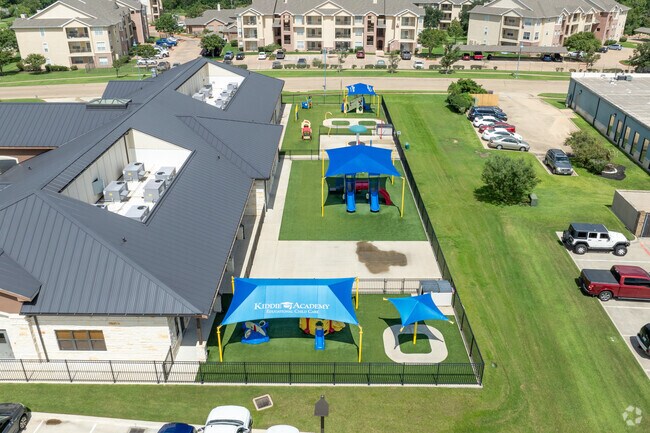 Kids delight in adventures on Kiddie Academy of Bryan's playground.