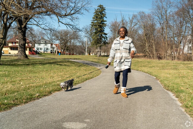 A Chicago Heights resident enjoys the sunshine while walking her dog at McEldowney Park.