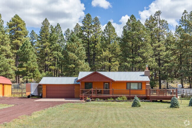 Homes sit along dirt roads surrounded by ponderosa pines in Mormon Lake.