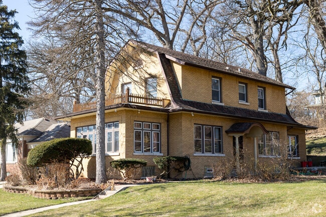 Georgian style home sit behind mature tree on the historic streets of Morgan Park.