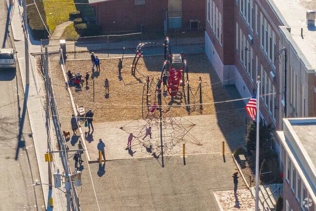 Students play on the playground at Atherton Hough Elementary School in Quincy, MA.