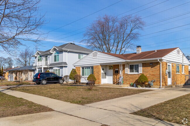 Mid-century ranch homes sit beside two story new traditional homes in Wheeling.