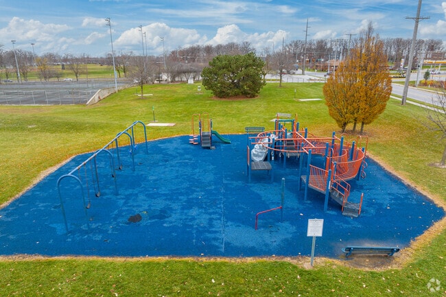 Families enjoy a soft-surface playground at Tillman Park, less than a mile from Morningside-Terrace.