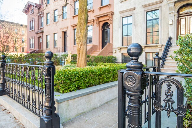 Some homes in Carroll Gardens have small fenced-in front yards.