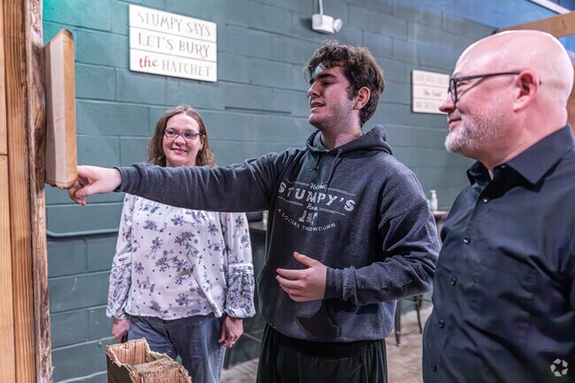 A staffer explains some games you can play at Stumpy's Hatchet House in Buckley District.