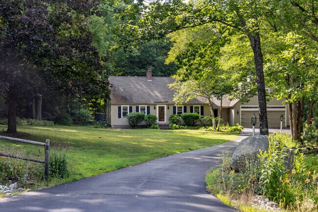 This Cape Cod sits comfortable on a large shady lot in the Bow area.