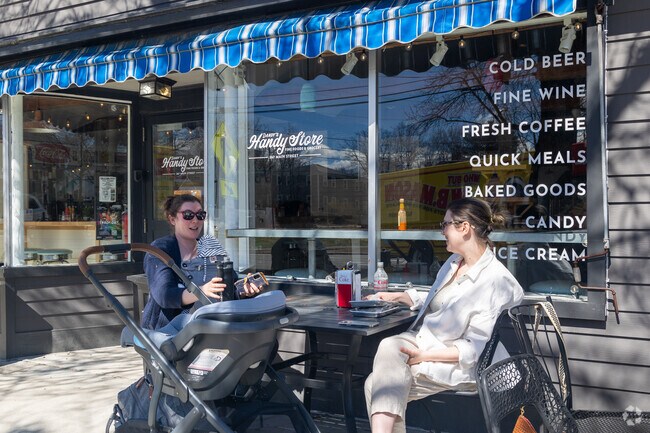 Friends enjoy the afternoon at a sidewalk cafe near Cumberland Center.