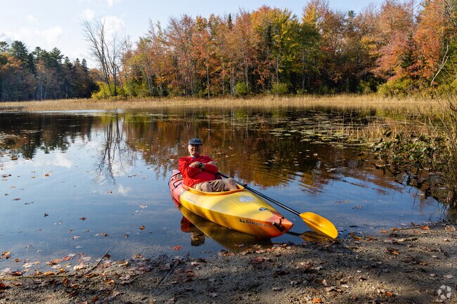 Runaround Pond Recreation Area in Durham, ME, is a popular destination for kayaking, fishing, and nature walks amid tranquil waters and lush greenery.
